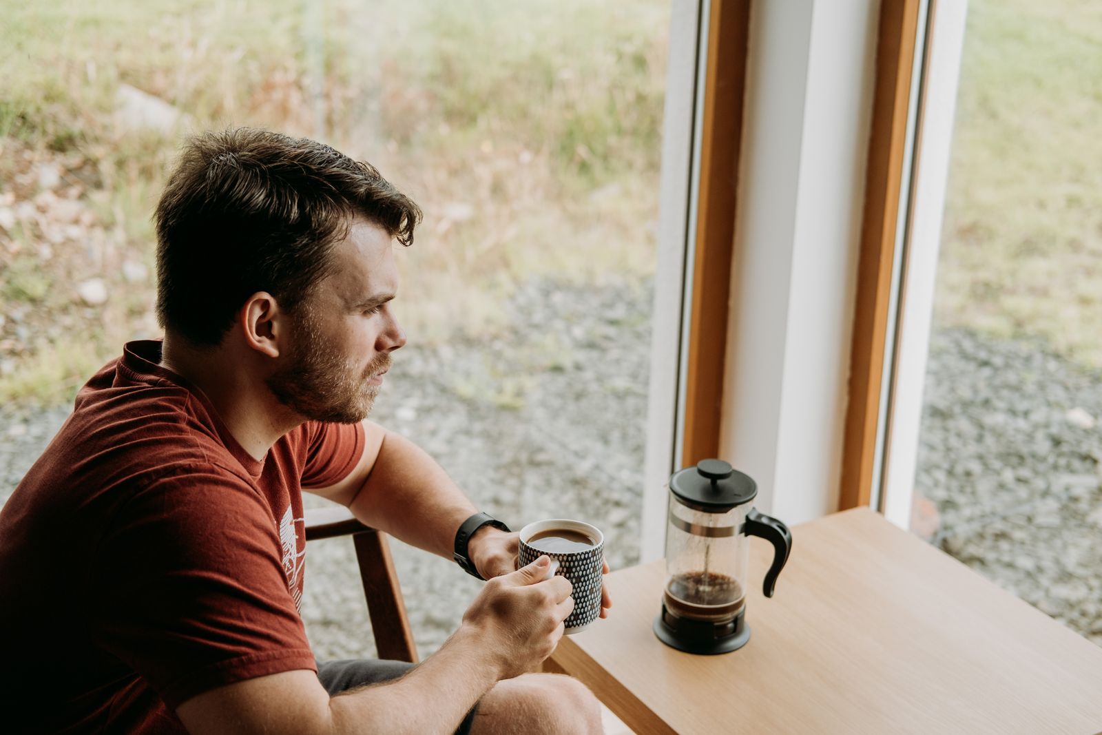 A man having coffee by the window in the early morning